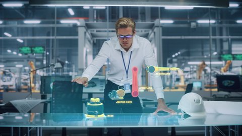 Industry 4.0 High-Tech Factory: Robotics Engineer Working on Robot Arm Design, Using Augmented Reality Hologram to Manipulate 3D Model by Gestures. Futuristic Engineering with Digital Technology