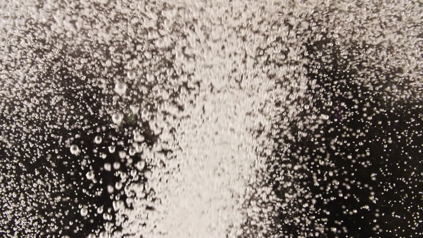 Effervescent tablet aspirin. Pill falling down in water on black background. The medicine concept, health care, treatment. Slow motion. Macro shot.