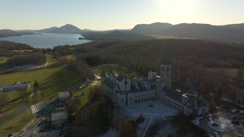 Beautiful Canadian Landscape And The Famous St. Benoit du Lac Church In Sunset - aerial shot