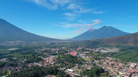 Volcano Acatenango and Volcano de Fuego near Antigua, Guatemala suburbs. 4K Drone.