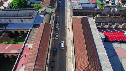 Antigua, Guatemala. 4K Drone. White Car Driving Through Colonial Cobblestone Streets.