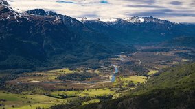 Timelapse video. Top shot of Manso river surrounded by native forests and mountains. Shot in 4k.