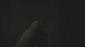 Male hand with a gas lighter. The man makes fire. super slow motion footage. gas lighter video.black background.