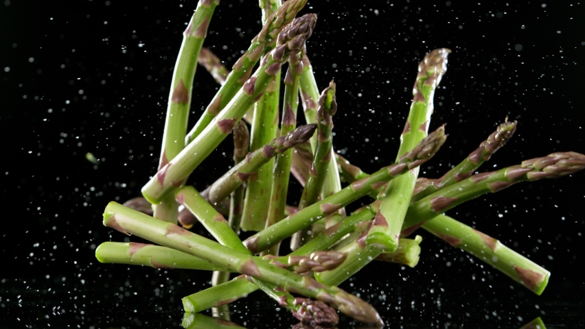 Super slow motion of falling green asparagus. Filmed on high speed cinematic camera at 1000 fps. - Powered by Shutterstock - Get 15% off with code: PIKWIZARD15