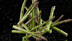Super slow motion of falling green asparagus. Filmed on high speed cinematic camera at 1000 fps. - Powered by Shutterstock - Get 15% off with code: PIKWIZARD15
