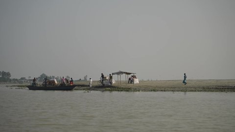 Dhaka, Bangladesh - November 30 2021: Boats taking passengers from the river bang