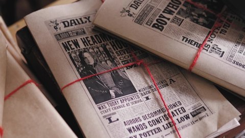 Minsk, Belarus\ 11.11.2021: Newspapers lying on the table, magical papers based on a movie Harry Potter boy wanted