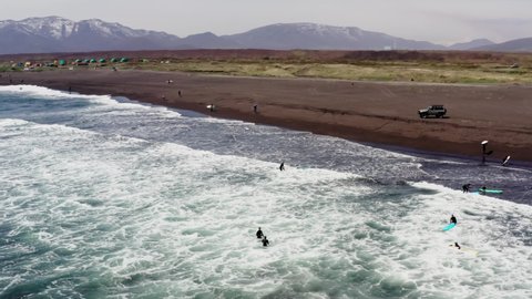 Aerial drone shot of surfers on lineup 
 at the Khalaktyrsky beach, Kamchatka Peninsula, Far East of Russia