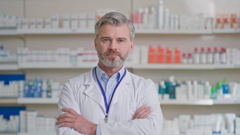 Portrait modern pharmacy doctor professional consultant crossing arms posing in apothecary. Drugstore. Healthcare workers. Medical sector.