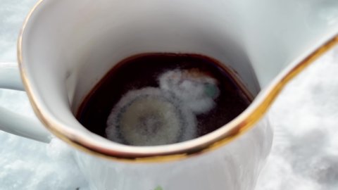 YUCK. Unhealthy and moldy tea drink left unattended in pocelain cup