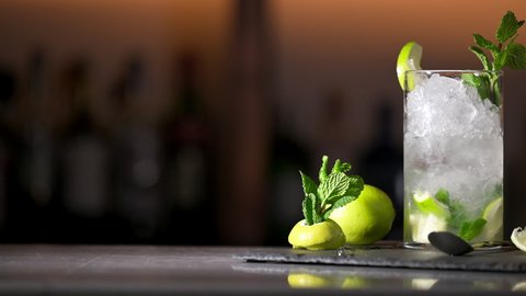 Delicious Fresh Mojito cocktail with ice, lime and mint, close-up, dolly shot. High quality FullHD footage