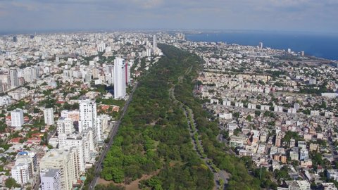 Parque Mirador del Sur at Santo Domingo and cityscape. Aerial backward