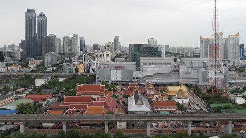 Aerial view of a temple in Rama 9 road, New CBD, Bangkok Downtown, Thailand. Financial district and business centers in smart urban city in Asia. Skyscraper and high-rise buildings.