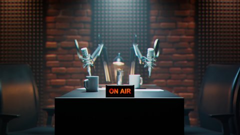 Podcast audio recording items in a climatic broadcasting studio. Professional microphones, comfortable chairs with a table in a cosy studio with brick walls. On-air red sign. Audio record. Journalism.
