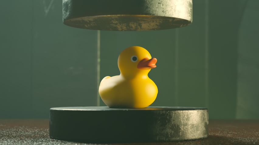 3d animation with a rubber duck in the industrial environment. The metal pneumatic press tries to squash up a cute yellow toy and fall apart on little pieces. Enormous resistant. Strong. Surprising. | Shutterstock HD Video #1083253453