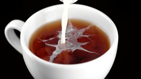 Tea with milk. Pour milk in tea, close up. 4K UHD video - Powered by Shutterstock - Get 15% off with code: PIKWIZARD15