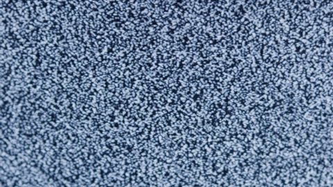 distorted white static noise interference on a small portable analog TV with a cathode ray tube, full frame real time, shutting down and turning on