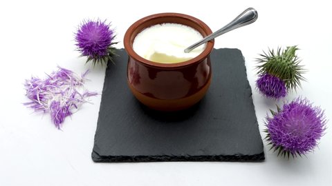 Showing a tablespoon of totally homemade curd made with natural thistle rennet on white background