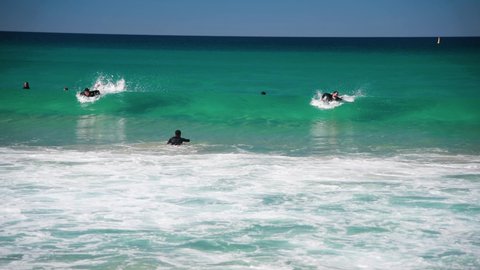 BONDI BEACH, AUSTRALIA - AUGUST 18, 2018: Surfers and waves on a sunny day