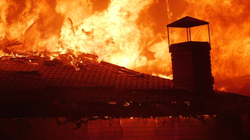 fire close-up. fire on the roof of the house. a burning at building house . home insurance apartment concept. huge fire blazes houses 911. property damage arson night protection Royalty-Free Stock Footage #1083288424