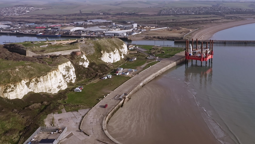 Newhaven port entrance with a Jack Up Rig in the bay and Newhaven fort overlooking the approaches, Aerial footage.