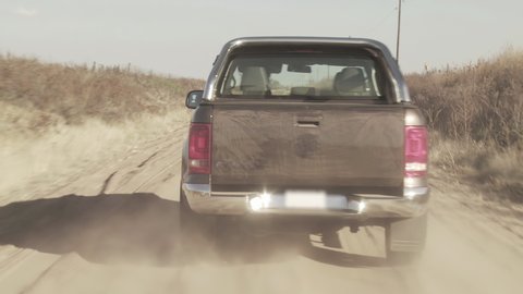 Pickup Truck Accelerating on Dusty Rural Road in Argentina. 4K Resolution.