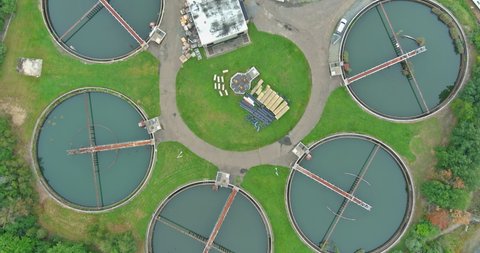 Aerial panoramic view of water treatment facilities sewage treatment plant with round sedimentation tanks of treatment facilities