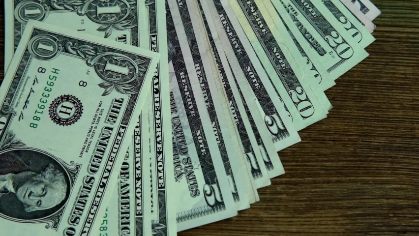 closeup paper 100 American dollars banknotes slowly fall on old wooden table, slide along it, concept of cash, savings, banking, return money debt, win in casino, get passive income, currency exchange Royalty-Free Stock Footage #1083317209