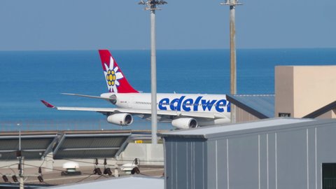PHUKET, THAILAND - DECEMBER 02, 2018: Airbus A340, HB-JMG of Edelweiss Air accelerating for takeoff Phuket Airport (HKT). Tourism and travel concept. Airport on a tropical island