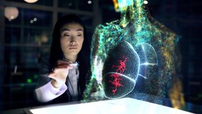 Asian woman Scientist analyses patient lungs and health indicators using augmented reality. Doctor work on 3D Simulated holographic lungs. Virus Detection 3d Animation. Artificial Intelligence Concept - Powered by Shutterstock - Get 15% off with code: PIKWIZARD15