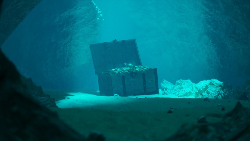 A secret treasure on the seabed in a mysterious underwater cave. An open old wood trunk is full of jewellery, coins and gold lighted by entering rays of the sun. Abounded pirate chest in blue water. | Shutterstock HD Video #1083335227