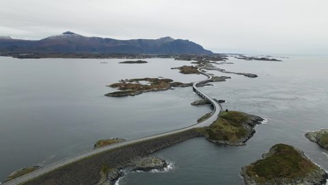 Atlantic Ocean Road Surrounded by Norwegian Sea And Rocky Islands in More and Romsdal, Norway on a Cloudy Day - aerial drone shot