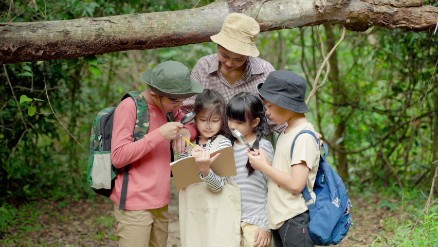 Asian female teachers are taking students on a nature trail to study nature from real places, educational concepts, adventures.