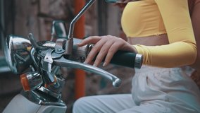 Cropped view of the two millenial diverse girls sitting at the bike and posing to the camera at the urban street with graffiti walls background. Contemporary life - Powered by Shutterstock - Get 15% off with code: PIKWIZARD15