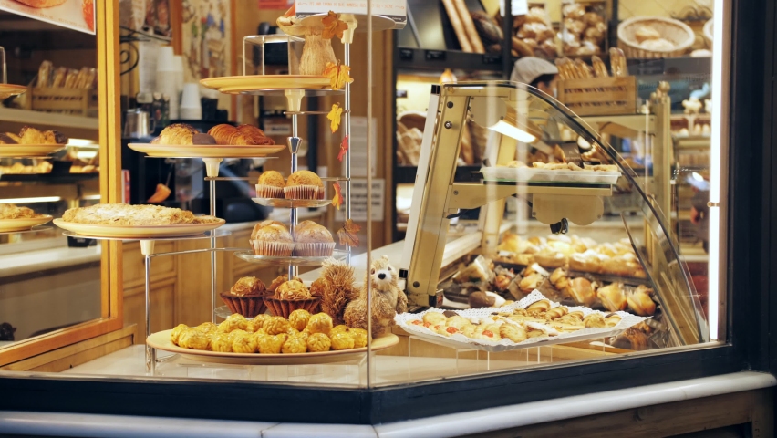 Delicious sweets pastries in patisserie cafe. Showcase of bakery close-up. Royalty-Free Stock Footage #1083351349