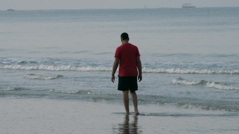Goa, India - November 27 2021: Tourist walking on the beach at Betalbatim Goa on the west coast of India.