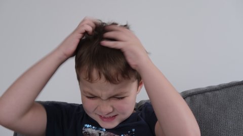 little boy scratching his head, allergies, lice