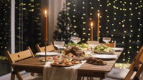 Festive dinner at home, burning candles on dining table. Celebrating new year, delicious dishes, cooked homemade food on plates. Christmas party concept, family tradition.  - Powered by Shutterstock - Get 15% off with code: PIKWIZARD15