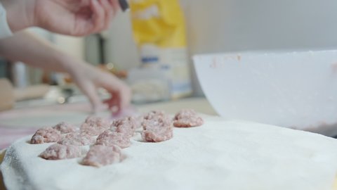 The close-up view of the cooking of the pelmeni. Pelmeni are dumplings of Russian cuisine