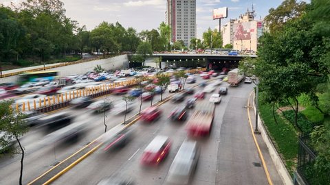 Time lapse view of cars driving along roadway in rush hour in Mexico City at daytime