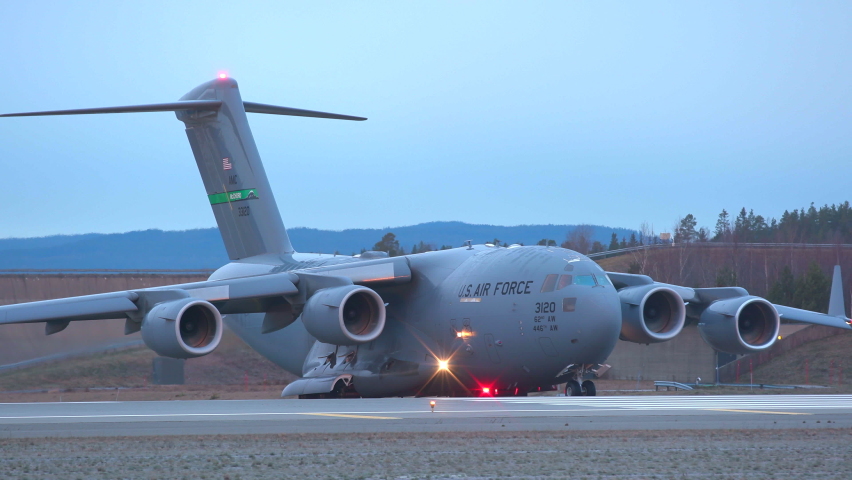 Oslo Airport Norway - November 22 2021: military aircraft c-17 globemaster III usaf us air force taxiing turning line up runway ambient sound