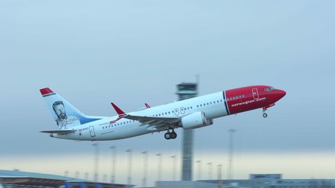 Oslo Airport Norway - November 20 2021: airplane boeing 737 8 max norwegian takeoff slow motion side view