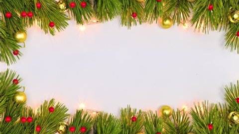6k Christmas frame on white theme made of fir twigs and blinking lights. Stop motion