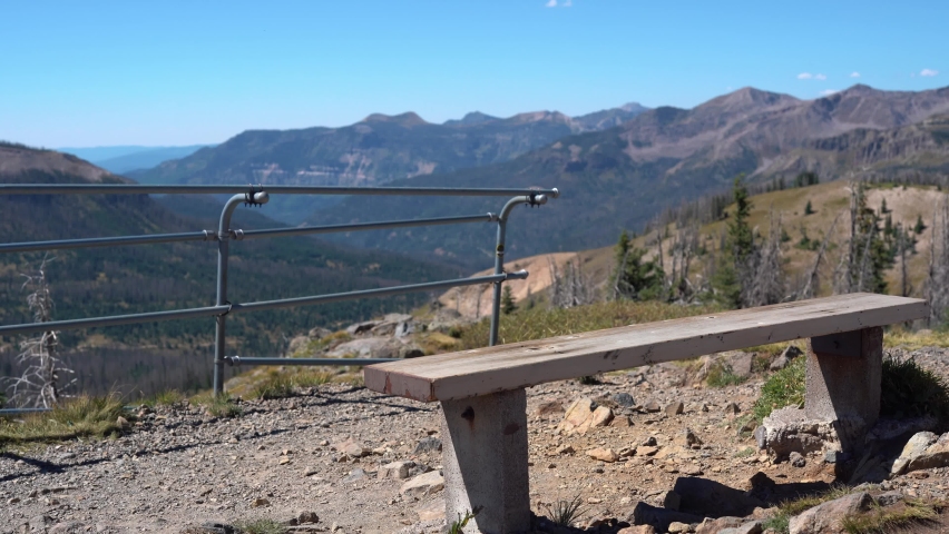 Zoom in shot after reaching top of mountain at Wolf Creek Pass during summer day - Peak in background against blue sky - Colorado,America