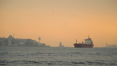 Istanbul Panorama of Container Ship on Bosporus during Sunset with Maiden's Tower