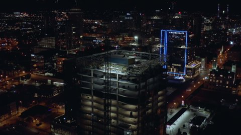 Nashville , TN , United States - 11 24 2021: Aerial of One 22 One tower under construction at night in downtown Nashville