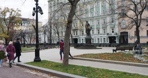 Moscow, Russia-October, 16, 2021. People walk on an autumn cloudy day in the city center near the monument to the poet S. Yesenin. Hand held.