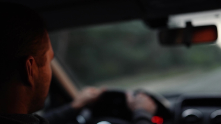 Young man inside car. Happy positive caucasian man driving car fast. Blurred background. Sunrise or sunset outside the window Royalty-Free Stock Footage #1083386968
