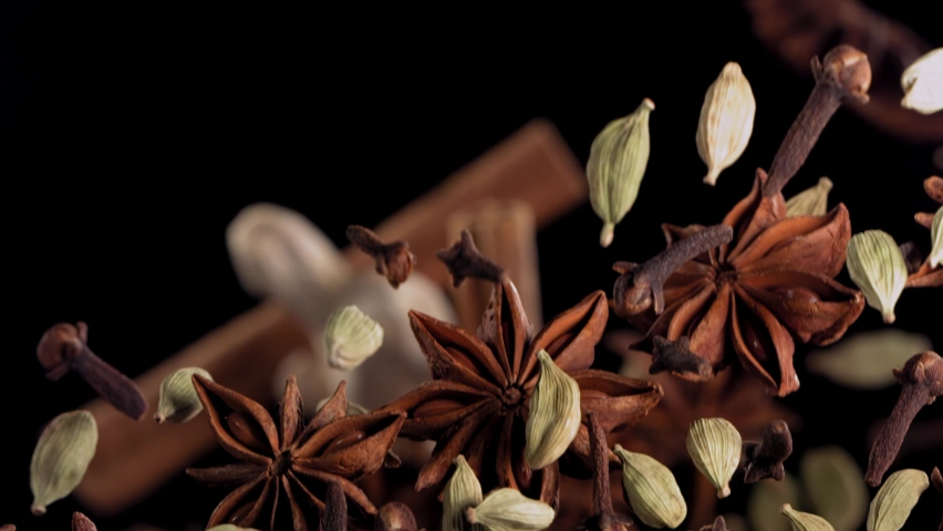 Super Slow Motion Shot of Flying Tea Mix Spices in Black Background. | Shutterstock HD Video #1083387820