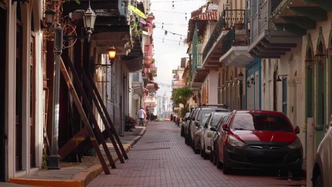 Panama City , Casco Viejo , Panama - 11 29 2021: A static shot of a narrow cobbled street surrounded by residential buildings which reflect the rich history of Hispanic architecture and design influence